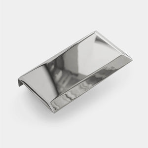A mirror polished shelf sits against a white background destined for a modern sofa