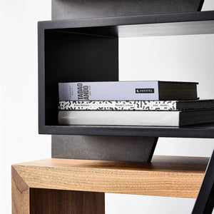 A stack of books makes the designer bookcase look purposeful as well as beautiful to look at