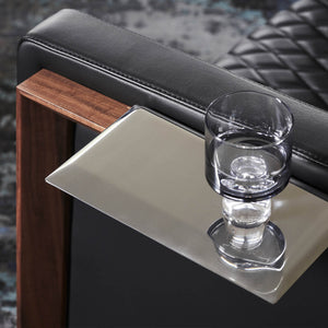 A whiskey glass rests effortlessly on a modern sofa arm in a Melbourne home