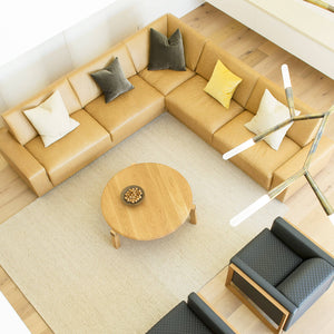 a birds eye view of this modern australian home features designer coffee tables by Australian designer FrancoCrea surrounded by lush leather sofas and armchairs