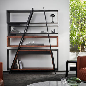 a bare wall is brought to life with by a sculptural metal and wood modern bookshelf and room divider sitting in front of it